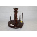 A 19th century turned mahogany spool or bobbin stand with central turned column, 17 cm x 14 cm.