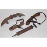 A group of three early 20th century wooden horn trainers with leather straps,