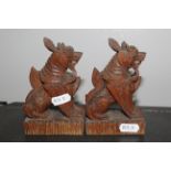 A pair of Siamese carved soft wood Dogs of Fo (temple lions), 13 cm high.