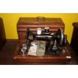 A late 19th century Pfaff manual sewing machine with inlaid rosewood veneered case,