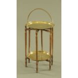 An Eastern folding table, two tier with brass trays. Largest diameter 33 cm.