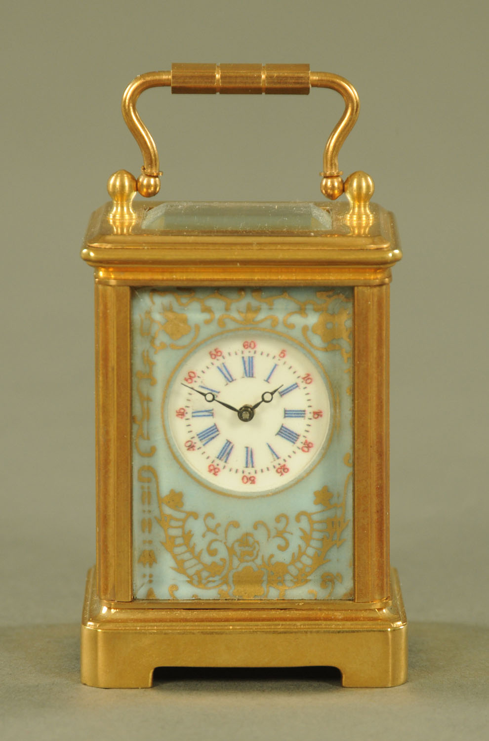 A miniature brass carriage clock, with porcelain panels, timepiece only.