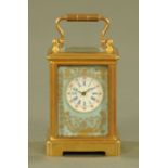 A miniature brass carriage clock, with porcelain panels, timepiece only.