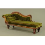 A Victorian chaise longue, with exposed carved frame, upholstered seat and bolster cushion.