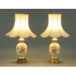 A pair of porcelain table lamps, each with brass base. Height excluding light fitting 40 cm.
