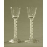 A pair of 18th century double air twist stem glasses, each with ogee bowl and conical foot.