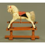 A Victorian dapple grey rocking horse, restored and on later safety stand.