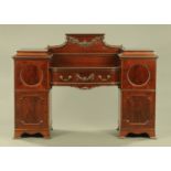 An Edwardian mahogany sideboard, with centre drop section fitted with drawers,