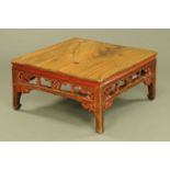 A Chinese painted low table, with pierced frieze raised on short legs.