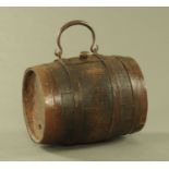 An antique oak small coopered barrel, with iron bindings and loop handle.