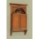 A late 19th/early 20th century Arts & Crafts hanging cupboard,