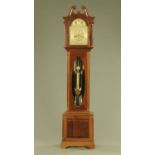 A large Edwardian mahogany longcase clock, with three train movement striking on nine gongs,