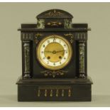 A Victorian black slate and marble mantle clock, with two train movement striking on a gong.