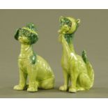 A pair of humorous green glazed cat and dog figurines. Tallest 20 cm.