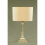 A silver plated Corinthian column table lamp, on square stepped base.
