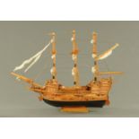 A model galleon, hand built, timber with rigging, last quarter 20th century. Length 86.5 cm.