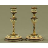A pair of Doulton Lambeth ware candlesticks, with impressed marks to base. Height 20 cm.