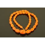 An orange amber necklace, 65 grams. Length 72 cm.