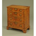 A Queen Anne style walnut veneered chest of drawers, with crossbanded edge,