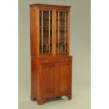 A 19th century mahogany bookcase on cupboard, with glazed panelled doors to the upper section,