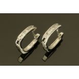 A pair of 18 ct white gold hoop earrings, set with diamonds weighing +/- .17 carats.