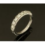 An 18 ct gold seven stone diamond ring, size N/O.