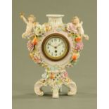 A continental porcelain clock, with single train movement and enamelled dial,