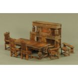 A miniature Elizabethan style carved oak dining room suite, comprising refectory table,