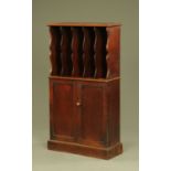 A Victorian estate cabinet, with filing apertures above a pair of panelled cupboard doors.