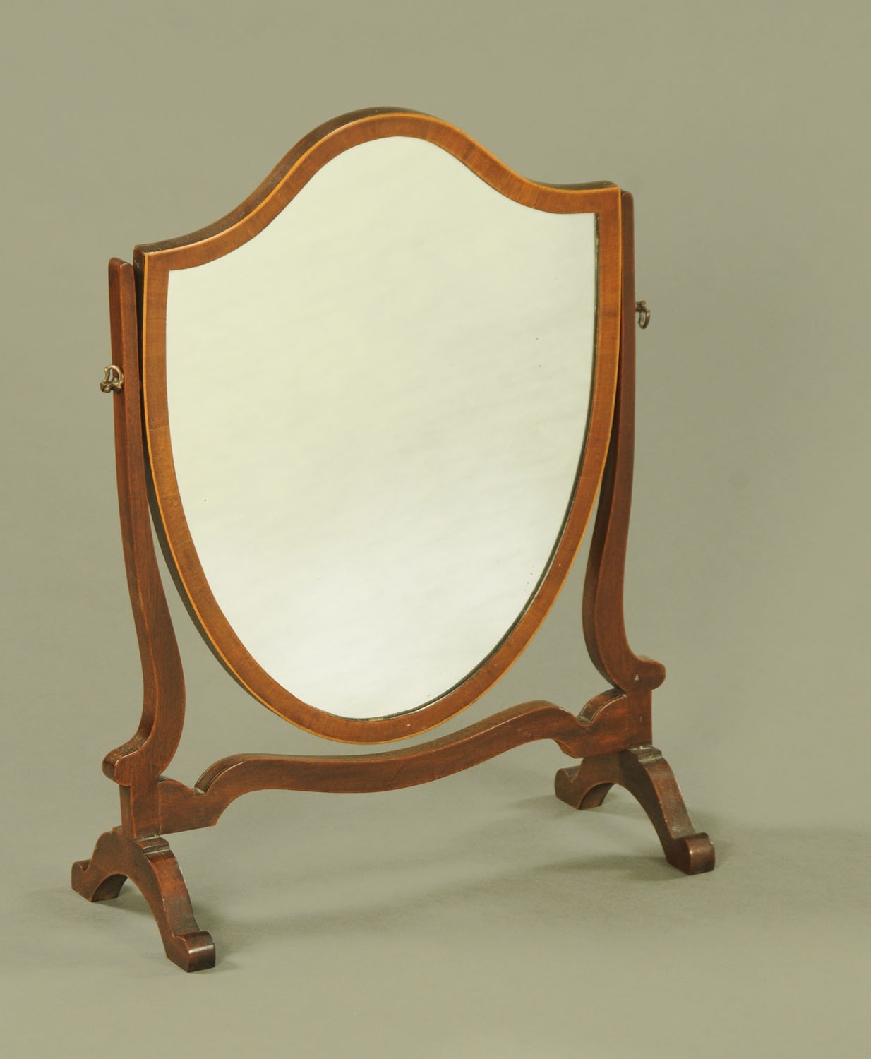 An Edwardian mahogany framed shield shaped toilet mirror, boxwood strung. Width 45 cm.