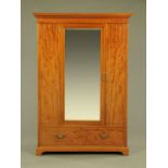 A Gillows of Lancaster inlaid mahogany wardrobe with mirror door and base drawer.