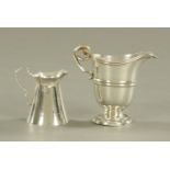 Two silver cream jugs, largest helmet shaped Sheffield 1892, the other Sheffield 1923, 140 grams.