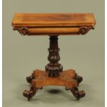 A William IV well figured mahogany turnover top tea table, with foliate carved column,