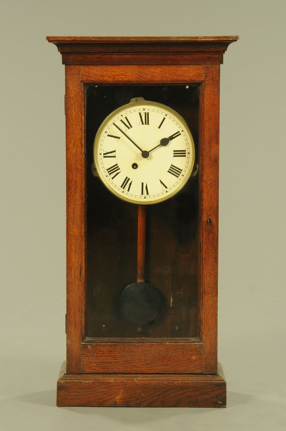 A late Victorian oak cased single fusee wall clock, with Roman numerals. Height 93 cm, width 47 cm.