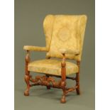 An early 20th century walnut armchair, with wing back,