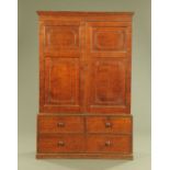 An early 19th century oak cupboard on chest,