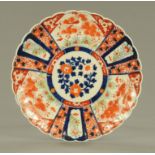 A 19th century Imari plaque, decorated in typical Imari colours. Diameter 38 cm.