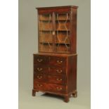 A George III mahogany secretaire bookcase, with dentil cornice above a pair of glazed doors,