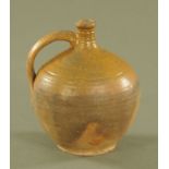 An antique stoneware flagon, part glazed. Height 24 cm.