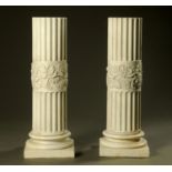 A pair of 19th century leaf carved and fluted Carrara marble columns,
