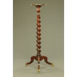 A mahogany torchere, with circular top,