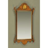 A Chippendale style walnut fretwork wall mirror, with gilt shell to head. Height 86 cm, width 44.