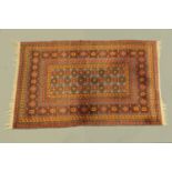 An Eastern fringed rug, with centre rectangular panel and multiple line border,