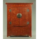 A Chinese lacquered wardrobe, with pair of doors and panelled sides and all raised on stile feet.