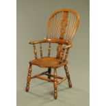 An elm broad arm Windsor chair, with pierced splat, outswept arms,