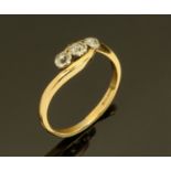 An 18 ct yellow gold three stone diamond ring, size P/Q.