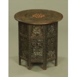 A late 19th century Moorish bone inlaid and carved circular table with folding octagonal base.
