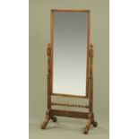 An early 20th century oak framed cheval mirror, rectangular with turned and twist columns.