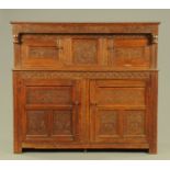 A 19th century oak court cupboard, carved with date 1684 and with Westmorland scrollwork.