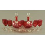 A pair of Victorian cranberry glass flasks, each with loop handle and stopper,